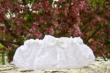 Lace garter with flowering tree background
