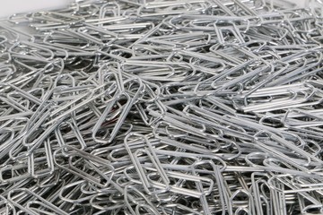 a heap of silver paperclips are lying in the studio