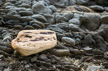 pebble stones on the sea beach, the rolling waves of the sea with foam