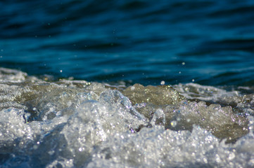 sea landscape is a pebbly beach with waves in white foam