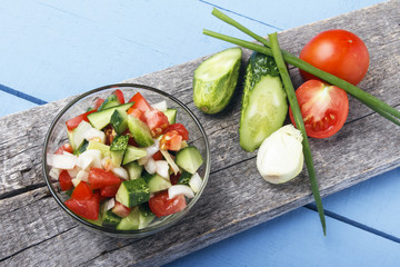 Fresh salad from organic vegetables on wooden board. Vegetarian and vegan food. Copy space