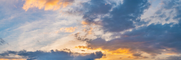 Naklejka na ściany i meble Vibrant panorama sunset sky on twilight time. Beautiful cirrus cloud. Panoramic image