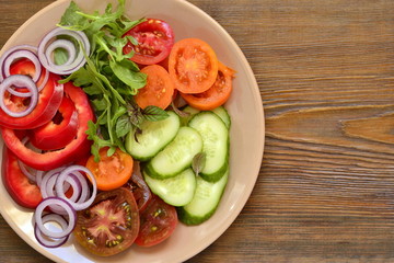 Colorful summer salad with fresh vegetables, top view, copy space