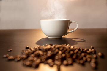 Hot coffee cup with blur coffee bean.