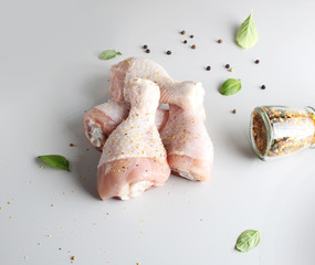 fresh chicken drumstick on a light background