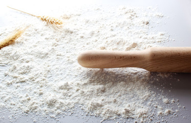 flour of a rolling ears spikelets of wheat on a light background