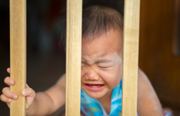 Portrait of Asian baby with face, who is sad and crying. With in