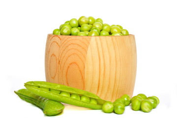 Wooden barrel with green raw fresh natural peas next whole and half-open pod and some peas on white background. Isolated