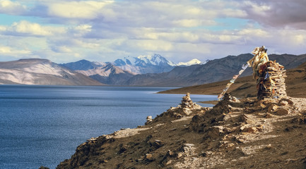 Tso Moriri lake at Ladakh India with view of holy rocks and distant mountain ranges.