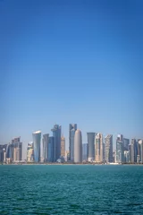 Foto op Plexiglas The skyline of Doha, Qatar, on a blue sky day, winter time, seen from the MIA Park © LMspencer