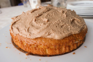 Homemade cake covered with coffee flavoured butter icing.