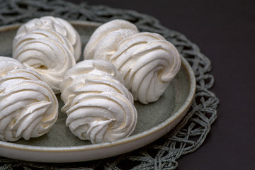 large airy white marshmallow on a gray plate