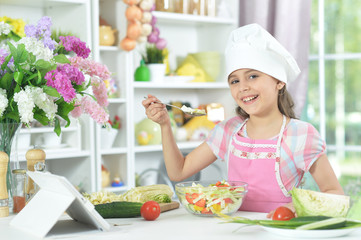 Portrait of cute little girl making dinner