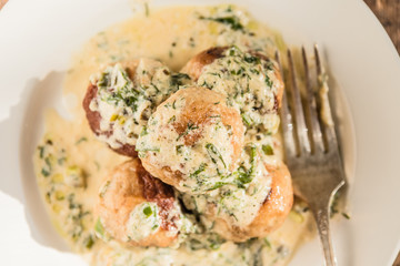 Swedish food - traditional chicken meatballs with cream sauce, top view, close-up