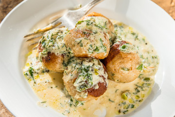 Swedish food - traditional chicken meatballs with cream sauce, top view, close-up