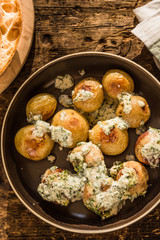 Swedish food - traditional chicken meatballs with cream sauce and new potatoes on a rustic wooden background