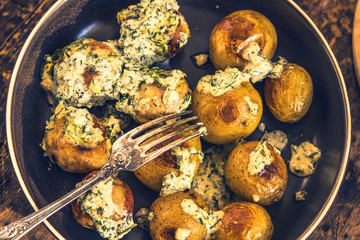 Swedish food - traditional chicken meatballs with cream sauce and new potatoes on a rustic wooden background