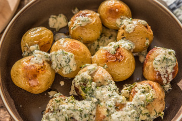 Swedish food - traditional chicken meatballs with cream sauce and new potatoes on a rustic wooden background