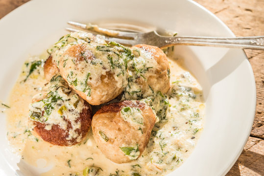 Swedish food - traditional chicken meatballs with cream sauce, top view, close-up