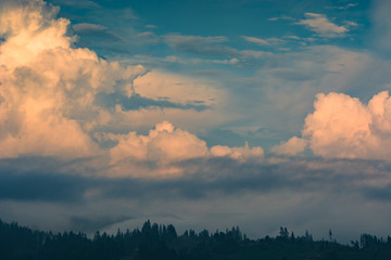 Majestic yellow clouds at sunset light