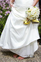 Bride carrying canary yellow heels