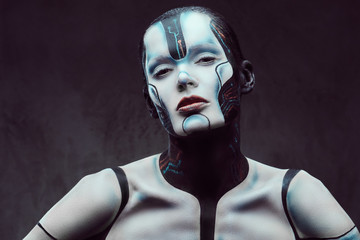 Sensual cyber woman with creative make-up. Technology and future concept. Isolated on a dark...