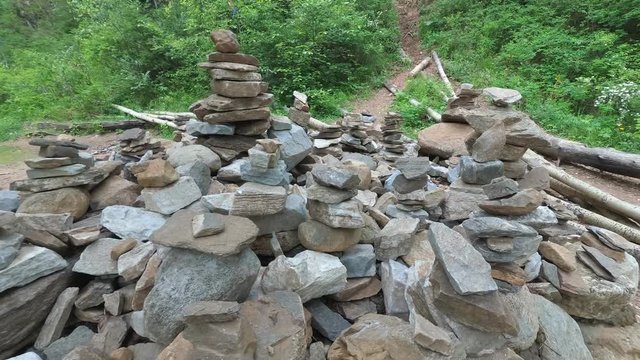 Fairy castle of stones in the forest. Buildings of stone, figures. Balanced stones stand firmly. Taken very close to a wide angle.