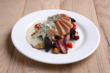 Fried meat fillet served with grilled onion, beet, pepper and zucchini