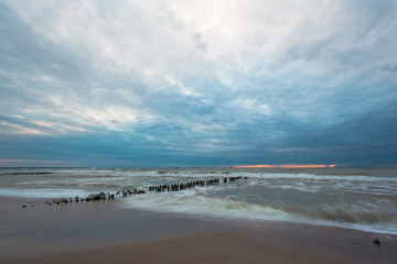 sea surface with waves and coast at dusk on long exposure