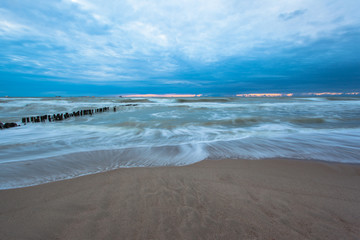 sea surface with waves and coast at dusk on long exposure