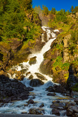 Waterfall Latefossen at sunset lights in summer in Norway