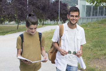 outdoor students with books and backpack
