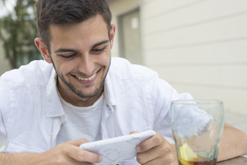 young or young adult smiling with the outdoor mobile phone in the cafeteria