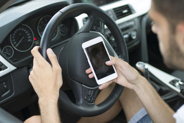 driver in the car with the mobile phone