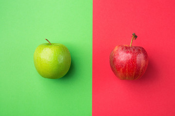 Ripe Organic Apples on Split Duotone Green Scarlet Red Background. Styled Creative Image. Vitamins Summer Vegan Fashion Concept. Food Poster with Copy Space