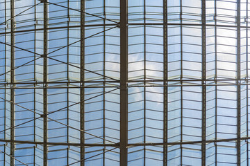 Glass roof with metal constructions through which the sky is visible
