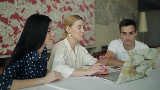 A representative of the wedding planners, talking with clients about the organization's upcoming wedding in a cozy atmosphere