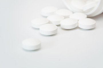 White pills and pill botle.