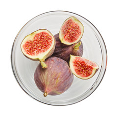 Fresh raw ripe figs in glass bowl isolated on white background. Ingredients for cooking. Top view.