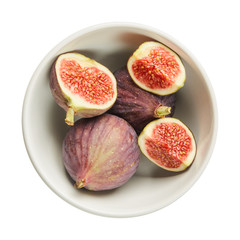 Fresh raw ripe figs in ceramic bowl isolated on white background. Ingredients for cooking. Top view.