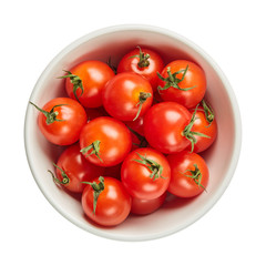 Fresh ripe tomatoes in ceramic bowl isolated on white background with green leaf. Ingredients for cooking. Top view.