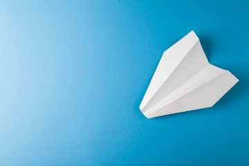 Paper airplane on a blue paper background