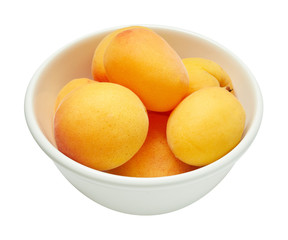 Fresh ripe apricot in ceramic bowl isolated on white background. Ingredients for cooking. Top view.