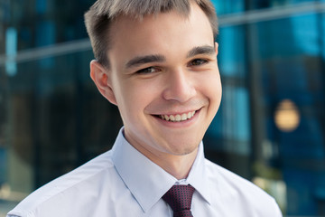 Successful young business man portrait smiling, close-up