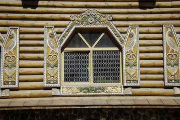 Old-fashioned window with shutters on a wooden wall