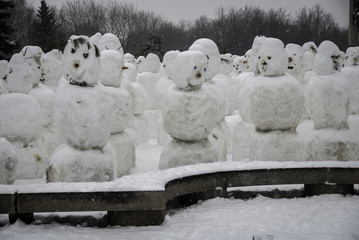 City snowmen during a snowfall