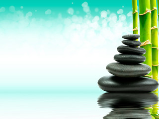 Obraz premium Zen basalt stones with green bamboo on water. Spa and Wellness concept.