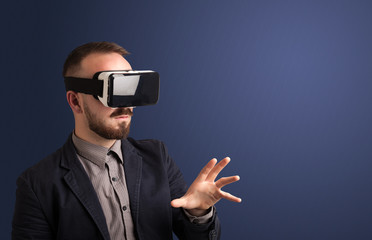 Amazed businessman with virtual reality goggles 