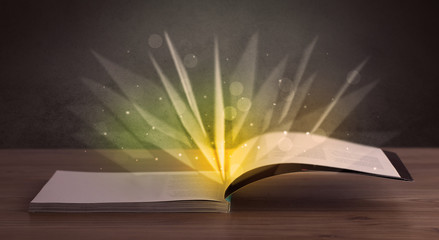 Yellow lights spreading from an open book 