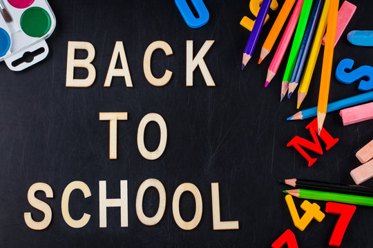 School supplies on blackboard background with copy space